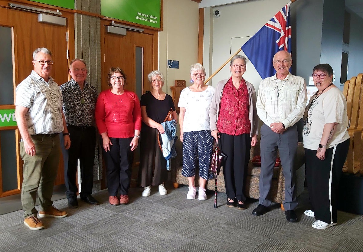 Group photo of senior reference group members in front of the council chamber