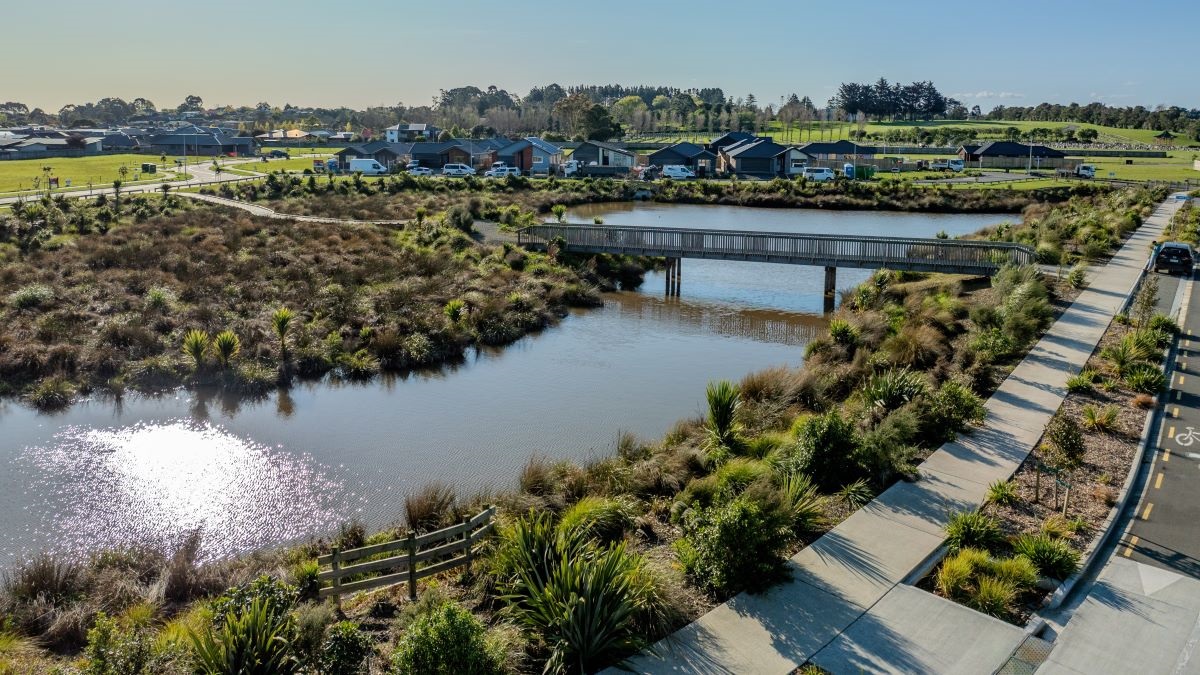 New homes are starting to emerge over the manmade lake at the Tamakuku development.