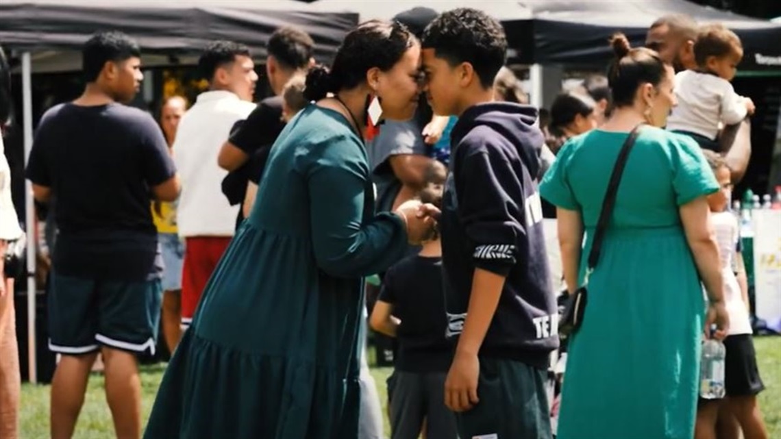 Two tamariki greet each other with a hongi at a Waitangi Day event in Te Marae o Hine.