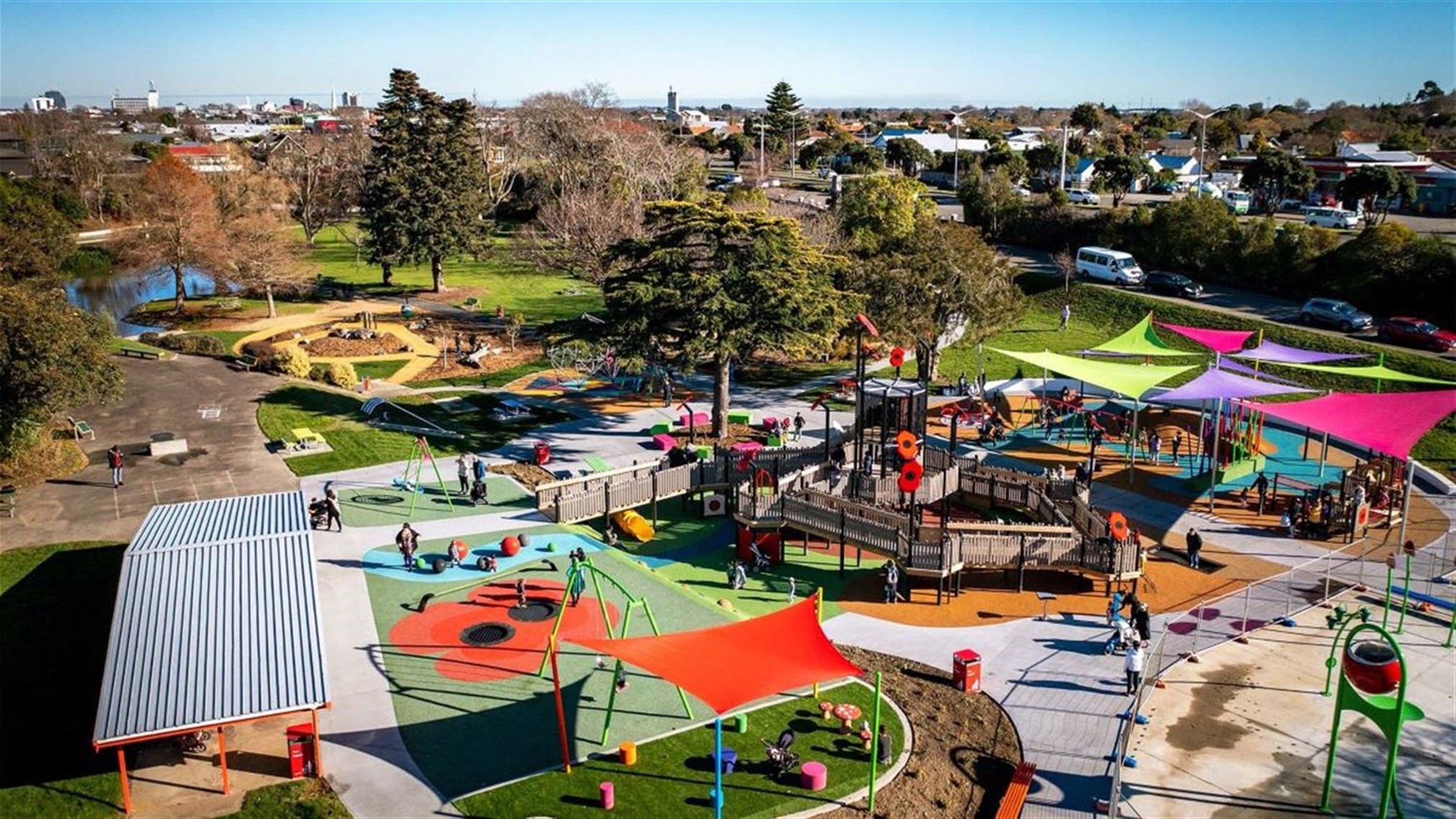 Photo shows lots of people enjoying the awesome new poppy-themed playground.